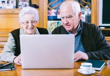 Senior couple working with Laptop at home